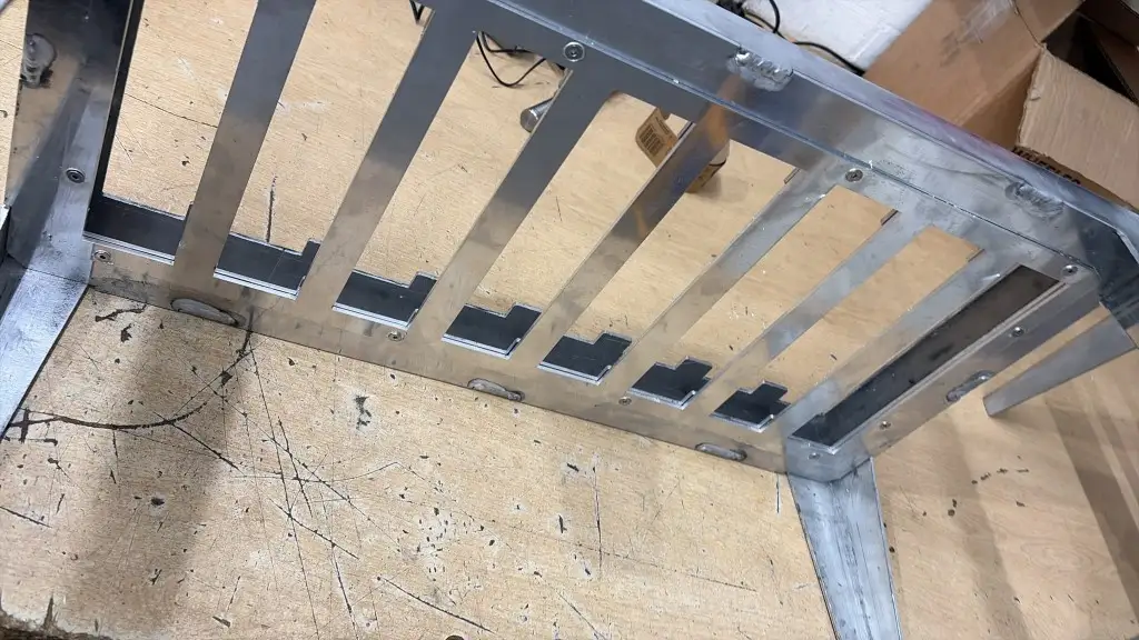 Close-up of TIG weld beads and fasteners on a polished 5083 aluminium tray frame