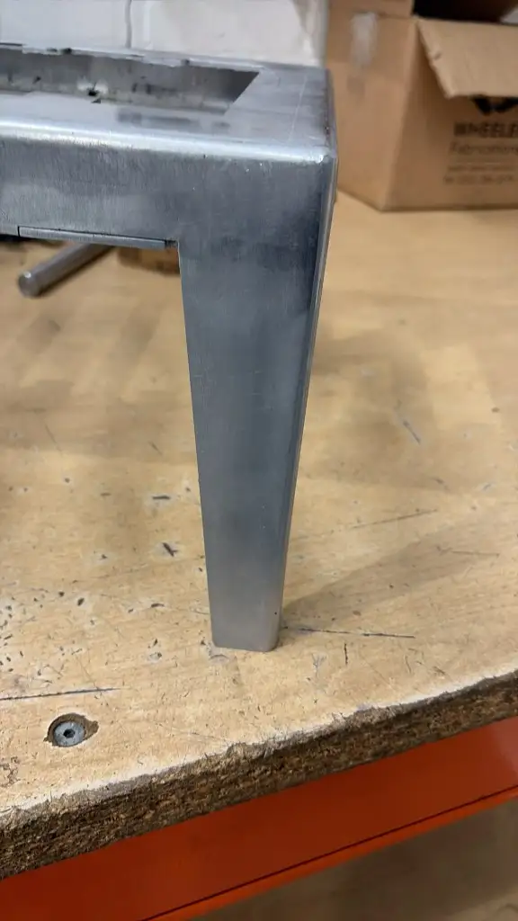 Tapered aluminium tray leg and polished corner joint, with a Wheeler Fabrications crate in the background