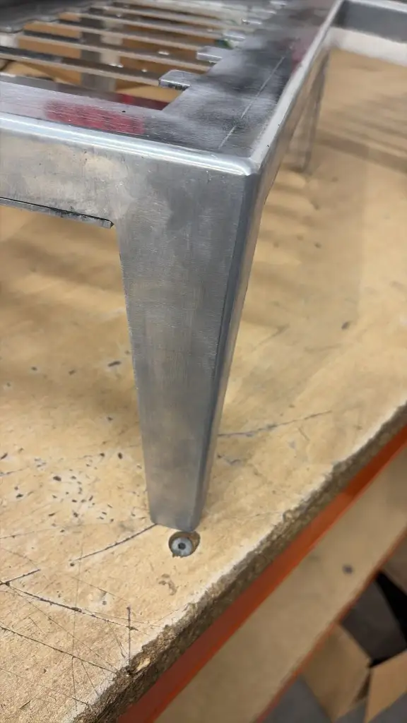 Close-up of a TIG-welded corner and tapered leg on a gently polished 5083 aluminium tray