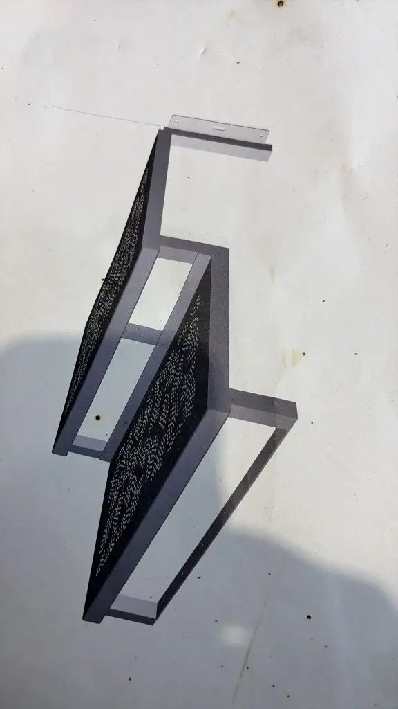 CAD model of a three-step metal staircase with laser-cut decorative treads and a mounting plate