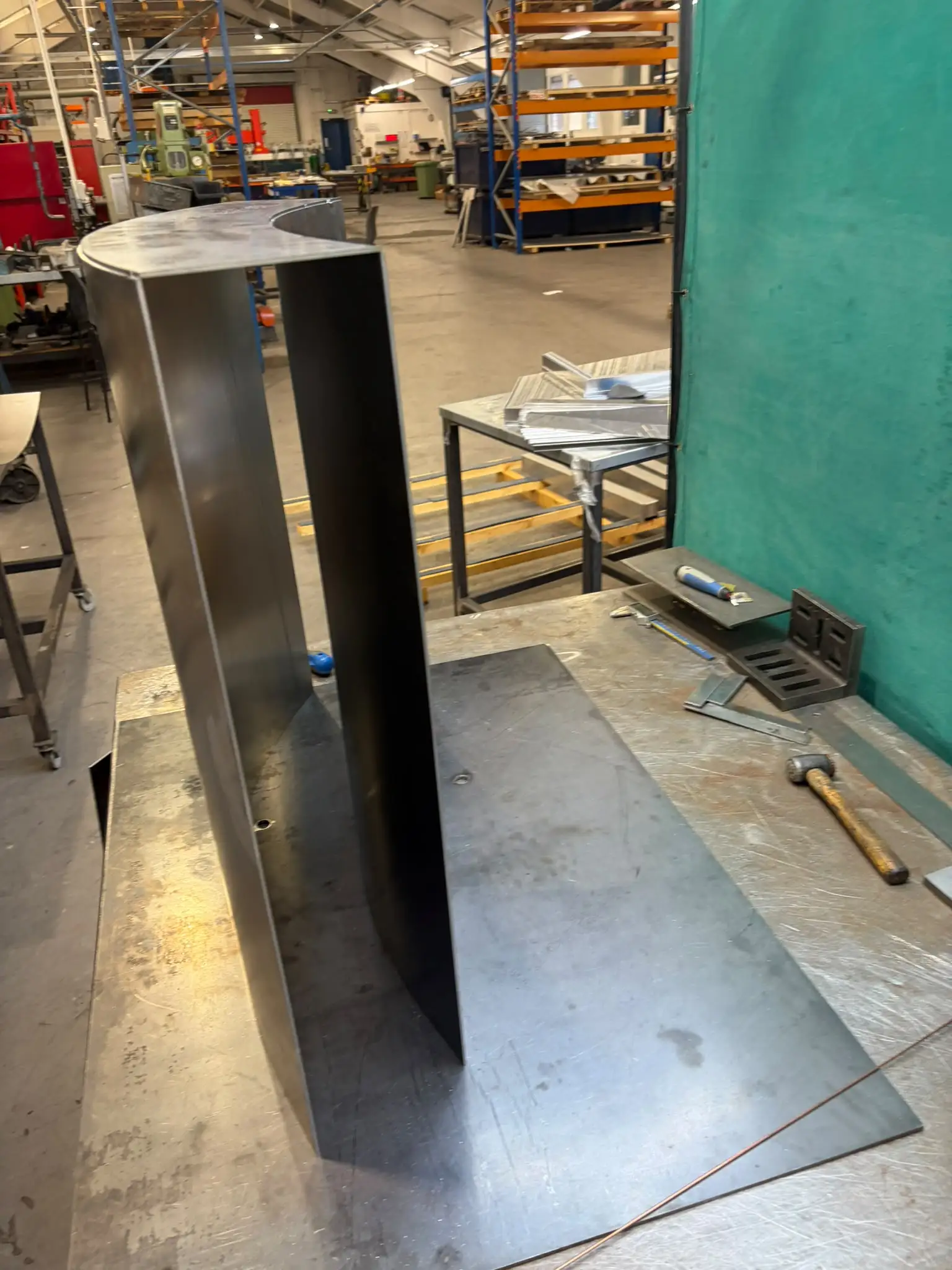 Curved upright panels and top plate tack-assembled on the welding table