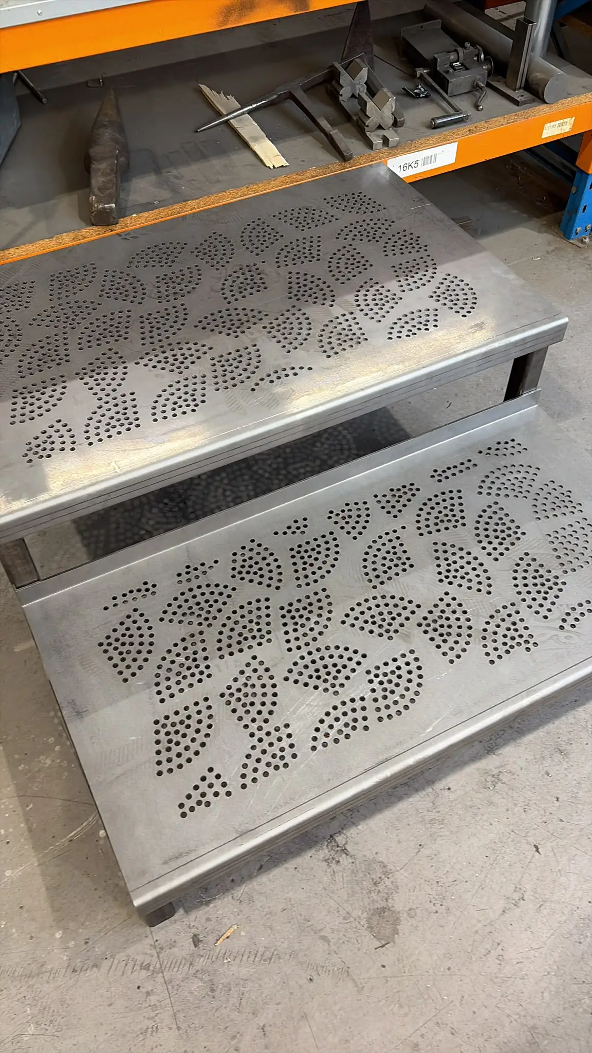 Close-up of the decorative patterned tread panels on a set of bespoke two-tread steps