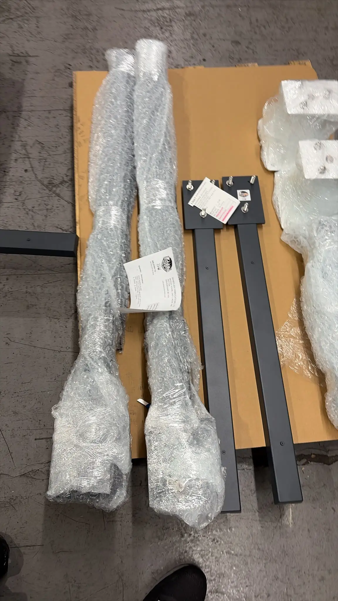 Load Bear brackets and bubble-wrapped parts laid out with a Wheeler Fabrications packing note
