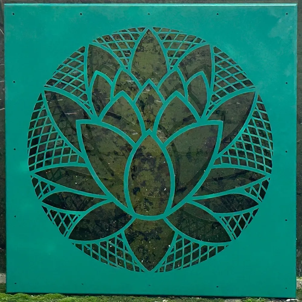 Teal powder-coated square garden screen with laser-cut lotus and geometric pattern