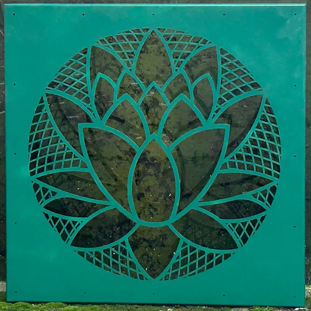 Teal powder-coated square garden screen with laser-cut lotus and geometric pattern