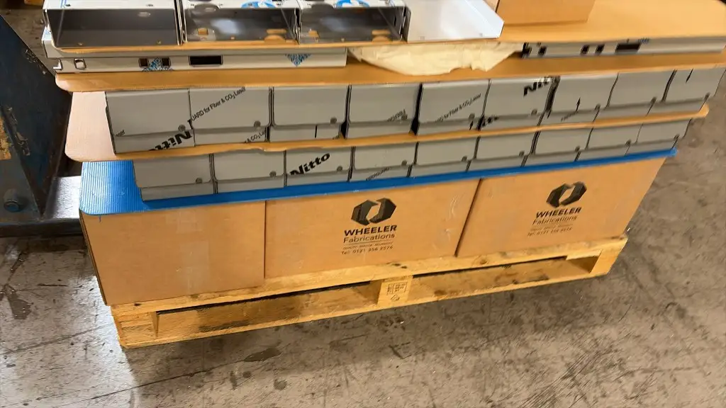 Production pallet of nitrogen laser-cut galvanised shutter hardware, nested in film, ready for folding and dispatch