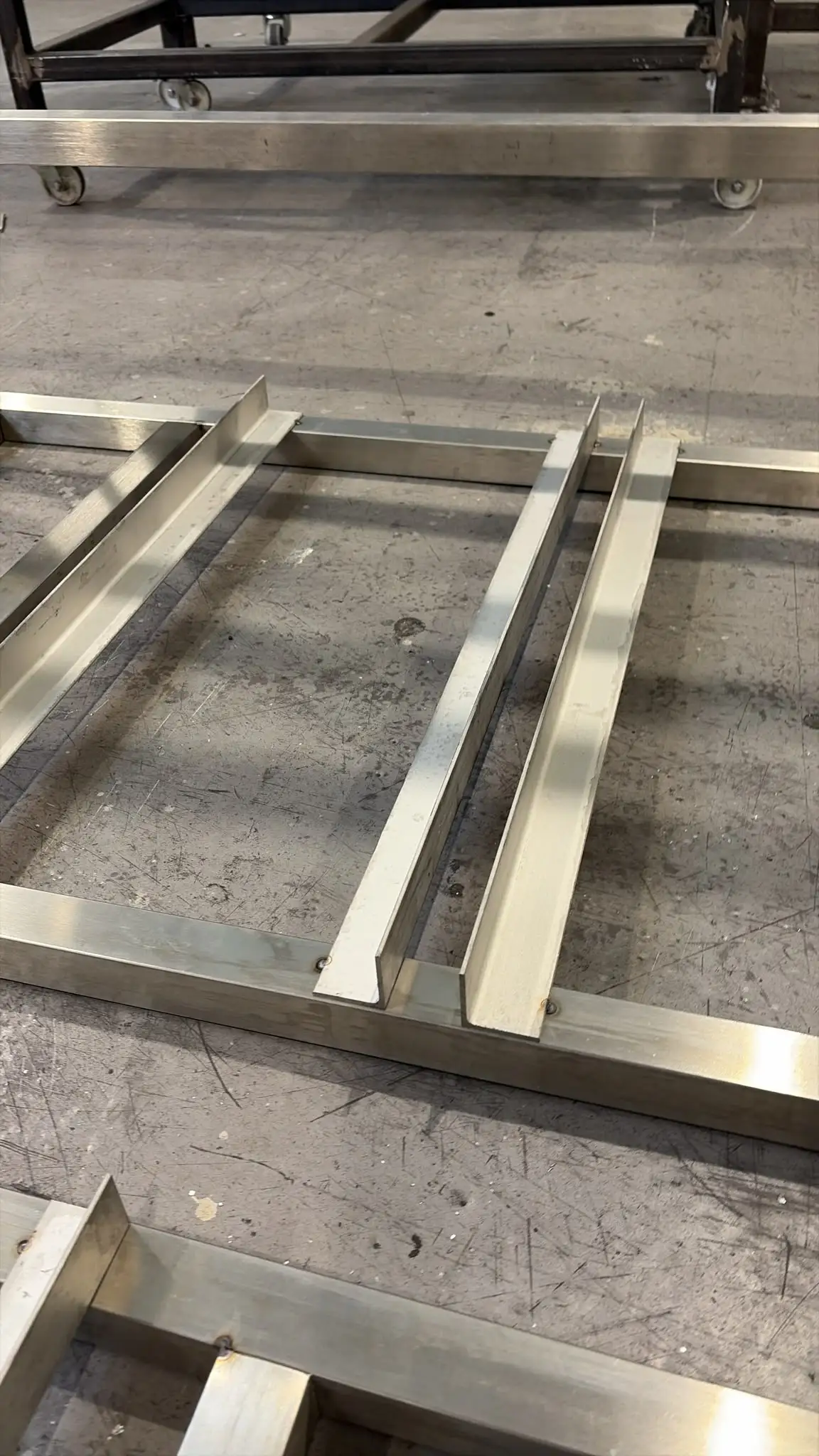 Stainless framework with cross-members, welded and dressed, on the workshop floor